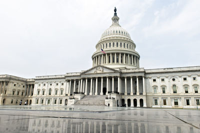 Low angle view of government building against cloudy sky