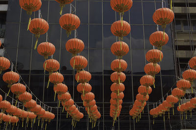 Low angle view of lanterns hanging against building