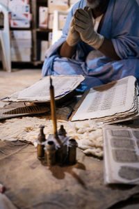 Midsection of man working on table