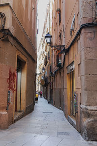 Carrer de raurich, street near ramblas in barcelona with walking people, spain.