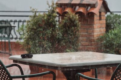 Chairs and table against wall in yard