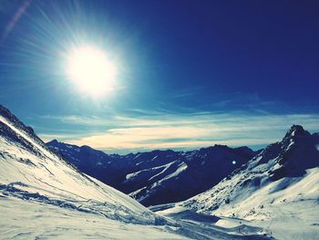 Scenic view of snow mountains against sky