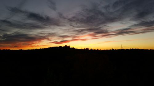 Silhouette of landscape against sunset sky