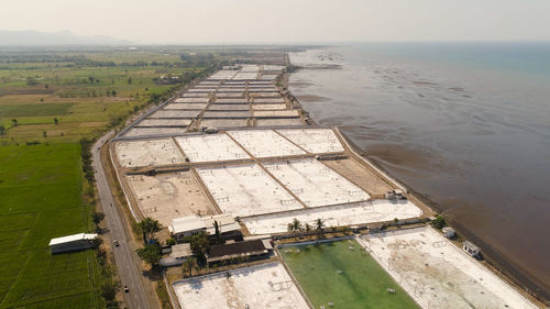 Shrimp farm, prawn farming with with aerator pump oxygenation water near ocean. 