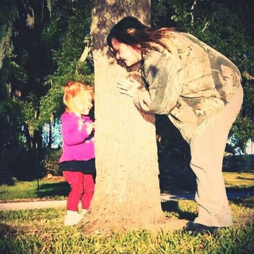 tree, art, human representation, sculpture, statue, art and craft, grass, creativity, park - man made space, field, day, standing, outdoors, tree trunk, growth, park