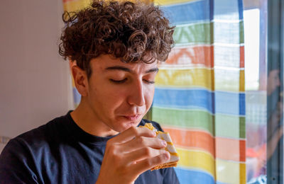 Close-up of young man standing at home