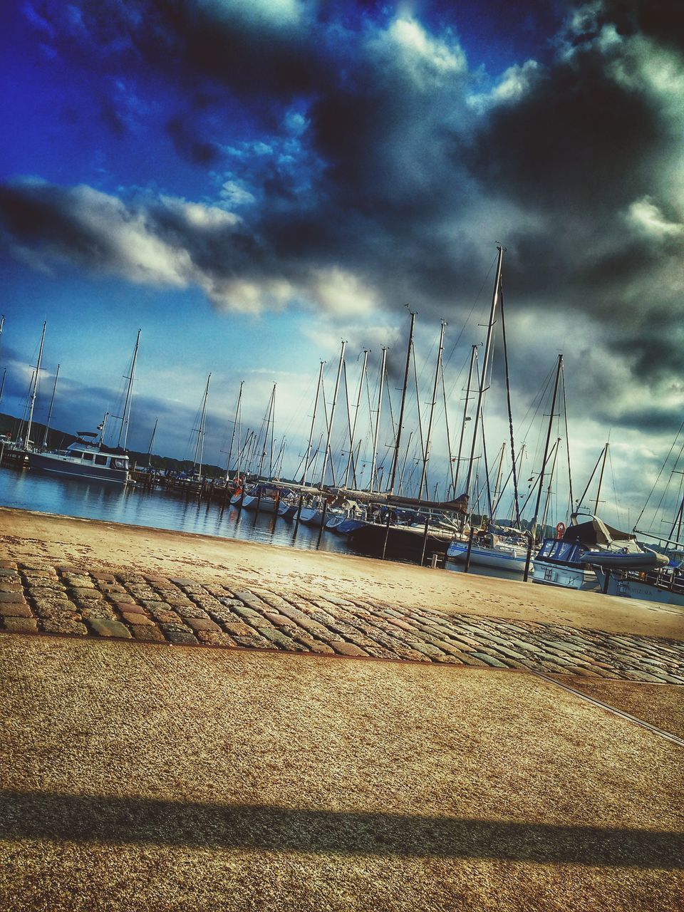 SAILBOATS MOORED IN MARINA