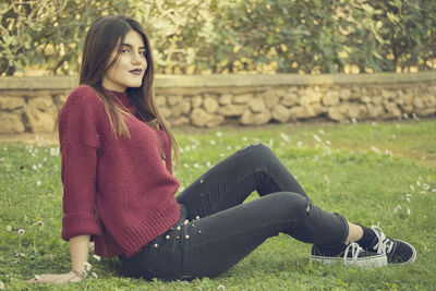 Young woman sitting in park