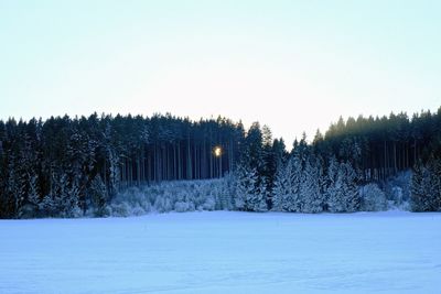 Snow covered landscape against clear sky