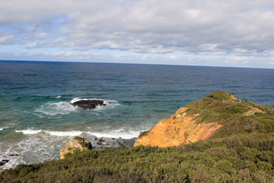 Scenic view of sea against cloudy sky