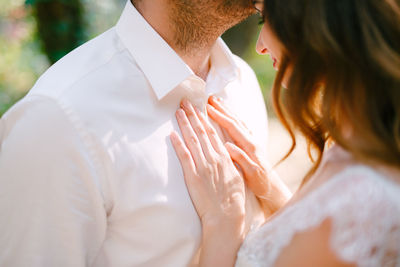 Midsection of couple holding hands