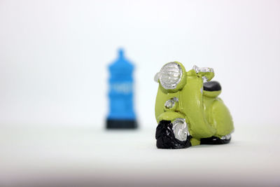 Close-up of toys on table against white background