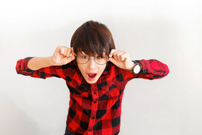 Portrait of boy standing against white background