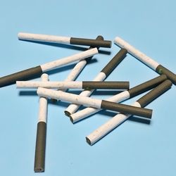 Close-up of cigarette against white background