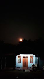 Illuminated building against sky at night