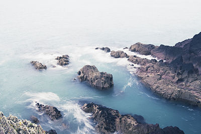 High angle view of rocks at sea shore