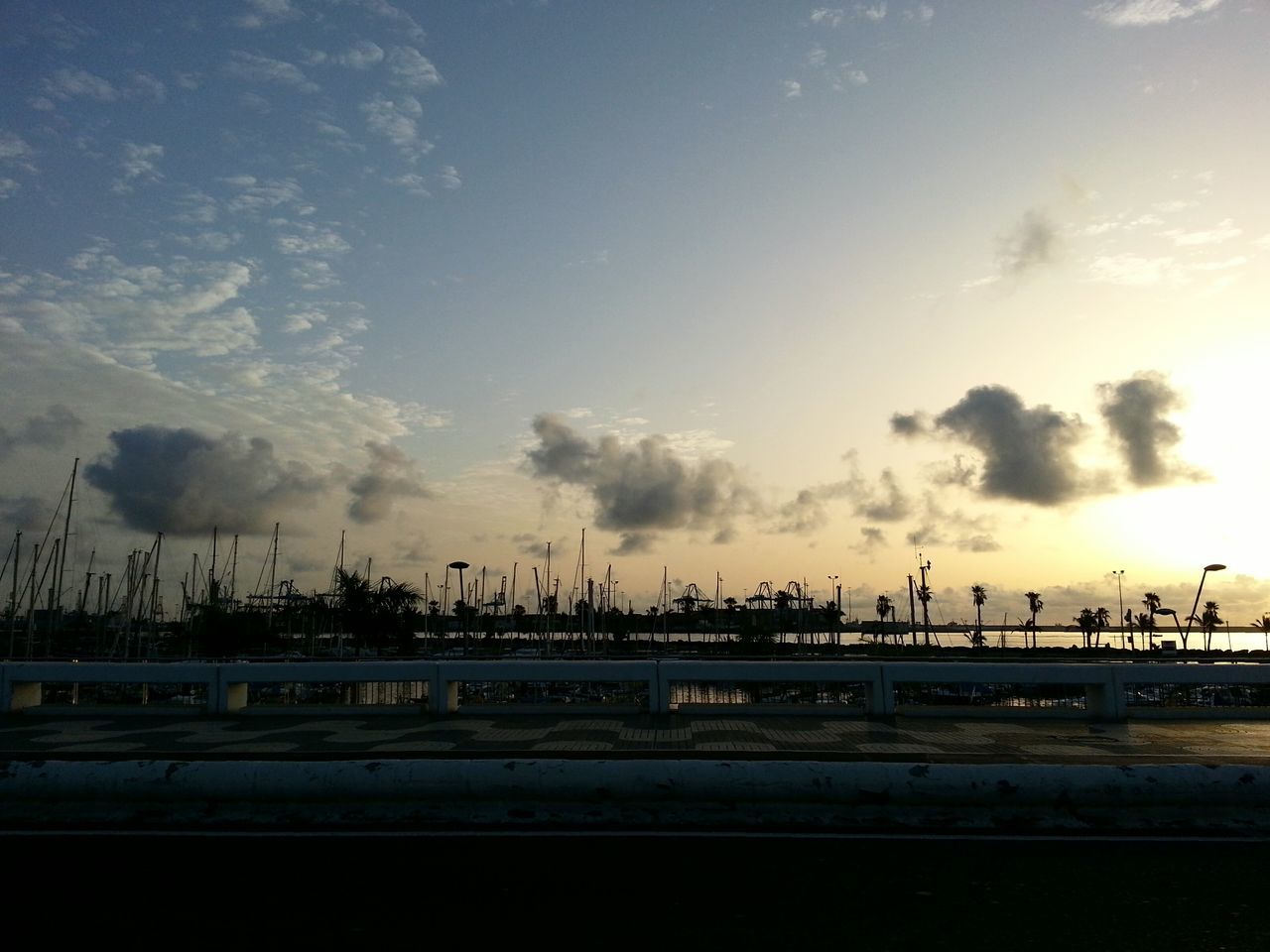 transportation, sky, cloud - sky, crane - construction machinery, mode of transport, built structure, public transportation, railroad track, connection, cloudy, architecture, rail transportation, dusk, industry, silhouette, bridge - man made structure, development, outdoors, railing, crane