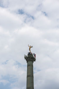 Low angle view of statue against sky