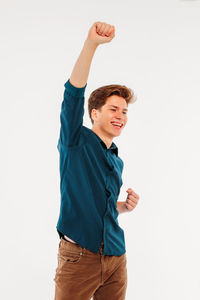 Smiling young man standing against white background