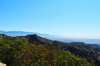 Scenic view of mountains against clear blue sky