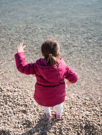 Rear view of girl on beach