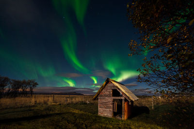 Built structure on field against sky at night