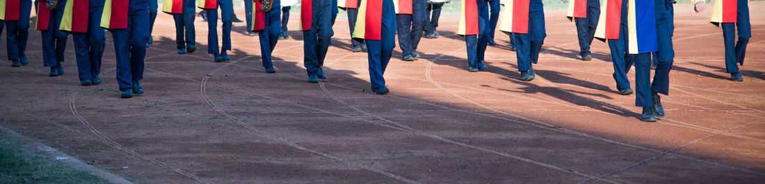 Low section of military people marching on track