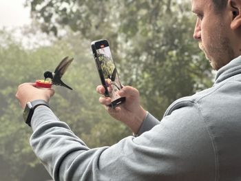 Side view of man using mobile phone