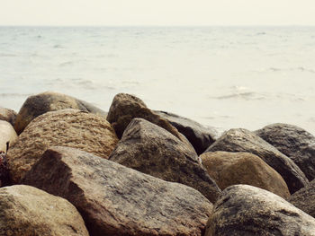 Rocks on beach against sky