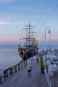 Pier over sea against sky during sunset