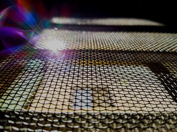 Full frame shot of illuminated metal grate