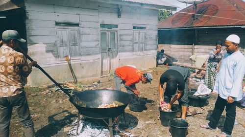 People working on barbecue grill