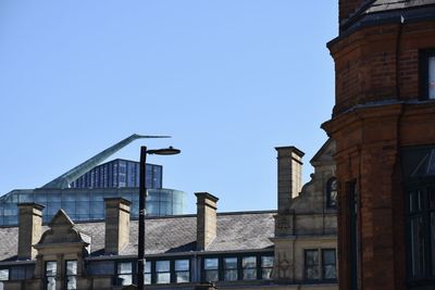 Low angle view of old building against clear blue sky