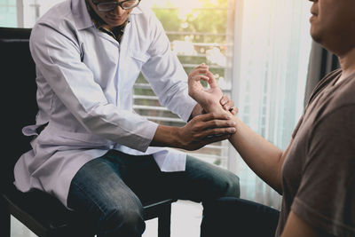 Side view of doctor examining patient at clinic