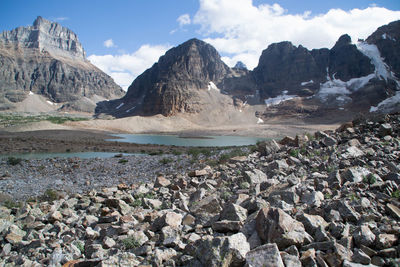 Scenic view of river and mountains against sky