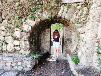 Rear view of woman standing in historic building