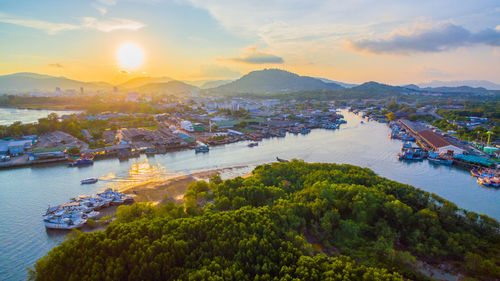 High angle view of bay against sky at sunset