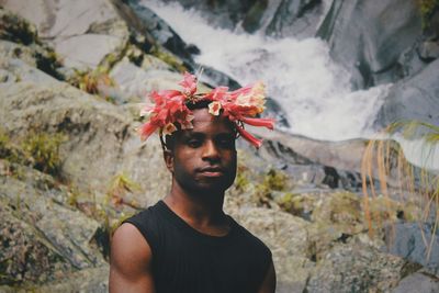 Portrait of young man standing on rock