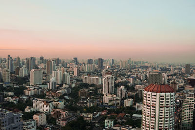 High angle view of modern buildings against sky during sunset