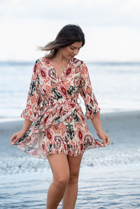 Young woman standing at beach