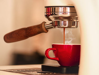 Close-up of espresso pouring from coffee machine. professional coffee brewing.