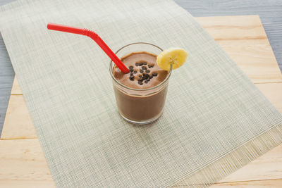 Chocolate banana shake topping sprinkled with chocolate chips, banana 