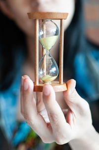 Close-up of hand holding glass candle