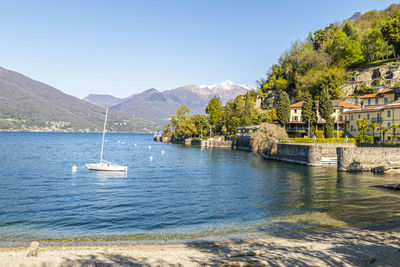 The colmegna coast in the lake maggiore with its beach and its villas