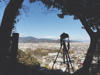 Man photographing on mountain against sky