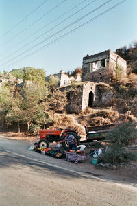 Cars on road by buildings against sky