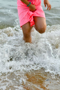 Girl splashing water in sea