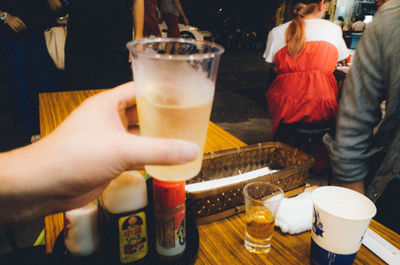 People drinking glass on table