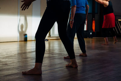 Low section of people dancing on hardwood floor