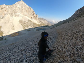 Rear view of man walking on mountain